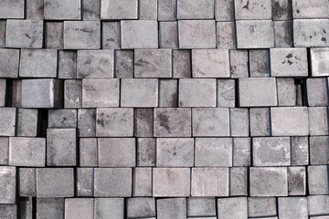 Stacked metal blocks forming industrial geometric pattern, metallic texture background for design and construction concepts