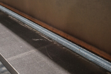 Close-up of precision metal welding seam, industrial steel fabrication detail, manufacturing craftsmanship and engineering quality concept