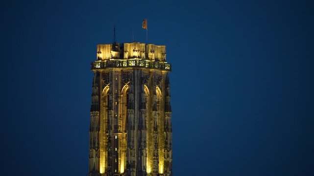 Lit up tower of St. Rumbold cathedral in Mechelen, static view