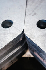 Close-up of precision-machined metal plates with drilled holes, industrial manufacturing detail and...
