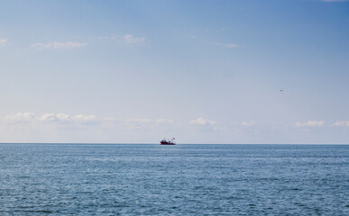 Fototapeta premium Shot of the fishing trawler on the horizon. Industry