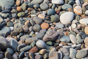 Close up shot of the pebbles of the beach. Background
