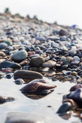 Close up shot of the pebbles of the beach. Background