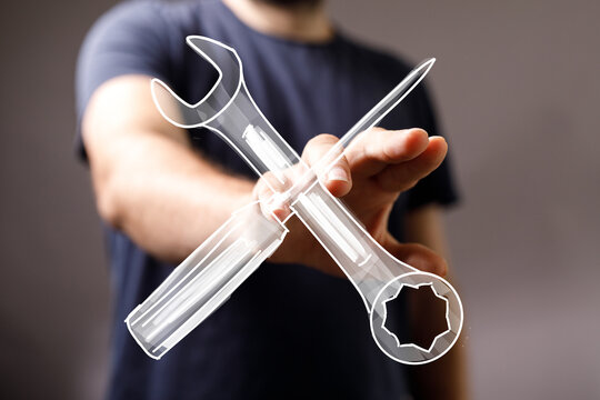 Image of a hand holding virtual wrench and screwdriver, symbolizing repair, maintenance, and technical support.