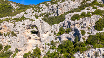 Aerial drone footage of Sa Preta Istampata, Sardinia, Italy – rock arch