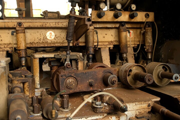 Old industrial machine equipment in lumber mill workshop on factory. Wood manufacturing and carpentry on plant, timber industry. Many broken metal details parts. Woodworking production manufacturing.