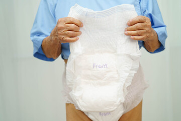 Fototapeta premium Asian senior woman patient wearing adult incontinence diaper pad in hospital.