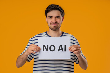 Young Man Holds Sign No Ai With Serious Face In Studio Visual Protest Against