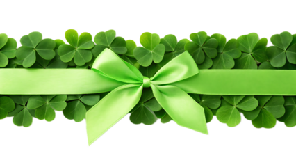 A green ribbon bow on a bed of shamrocks against a black background for st patrick's day holiday