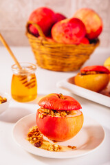 Sweet autumn dessert baked apples stuffed with muesli, nuts and honey.