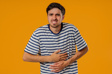 Man Squeezing Belly With Hands, Abdominal Pain. Adult Guy Suffering Stomach Ache