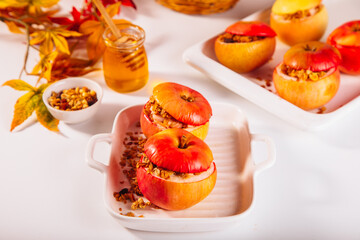 Sweet autumn dessert baked apples stuffed with muesli, nuts and honey.