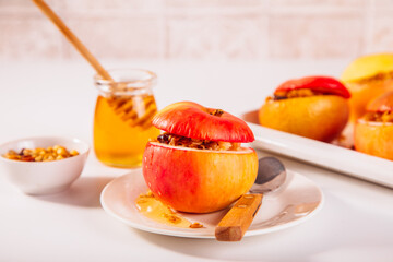 Sweet autumn dessert baked apples stuffed with muesli, nuts and honey.