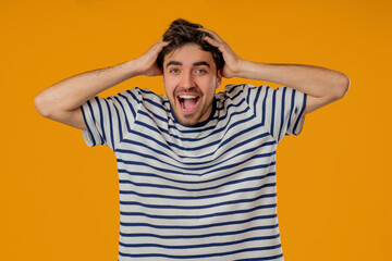 Amazed Man Shocked, Wow. Handsome Young Guy In Striped Shirt Surprised To Camera