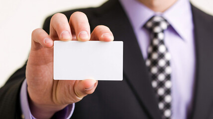 Professional businessman in sharp suit offers blank business card for your contact details and networking needs