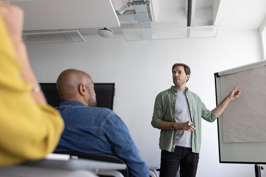 Tutor Engaging with adult students in a class