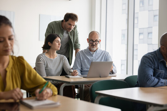Group Study Session with Laptop Interaction