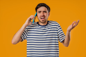 Angry Handsome Man Quarreling, Screaming Talking On Mobile Phone. Guy In Studio