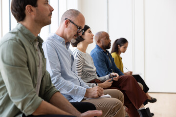 Man taking notes during a presentation