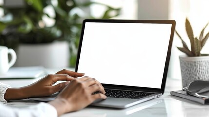 Focused female professional typing on a laptop at a modern workspace with copy space for ads