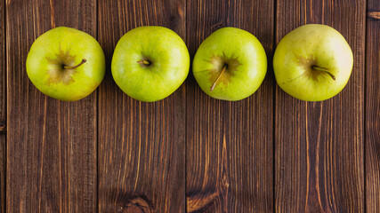 A few fresh apples on a wooden background