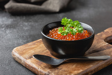 Red salmon caviar with parsley in a bowl