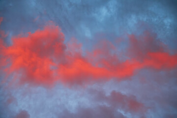 Beautiful sky with colorful golden and pink clouds at sunset.