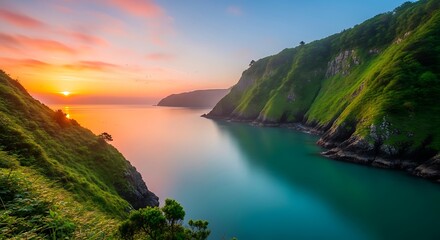 Coastal landscape at sunrise, emerald waters between lush green cliffs, golden sky reflection