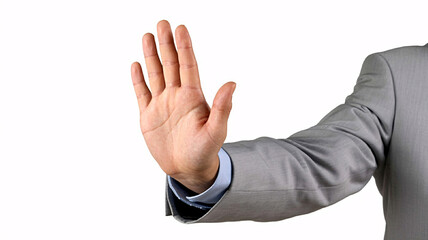Confident businessman in grey suit signals stop or halt with open palm, conveying refusal or barrier