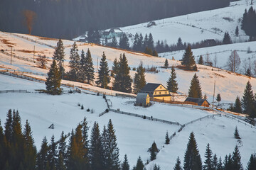Majestic snow-capped mountain peak with alpenglow at winter sunrise.