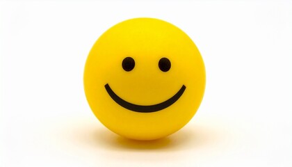 Fototapeta premium Yellow smiley face ball with black eyes and curved smile—placed on white surface with plain background
