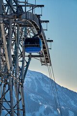 Gondola, cable car and ski lift with mountain, tree, blue sky on a sunny day at resort Krasnaya Polyana.