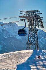 Gondola, cable car and ski lift with mountain, tree, blue sky on a sunny day at resort Krasnaya Polyana.