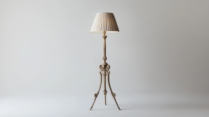 A standing lamp with a decorative tripod base and lampshade, shown alone on a white background.
