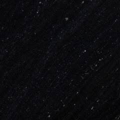 Obraz premium Photo of a dark, speckled surface resembling black granite with subtle hints of color