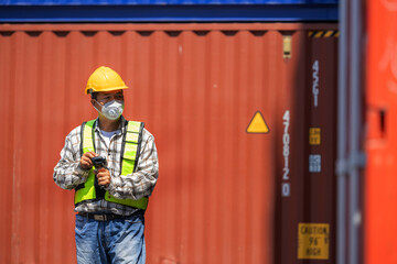 Foreman or worker work at Container cargo site check up goods in container. Foreman or worker checking on shipping containers. Logistics and shipping