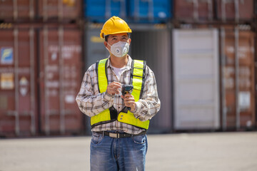 Foreman or worker work at Container cargo site check up goods in container. Foreman or worker checking on shipping containers. Logistics and shipping