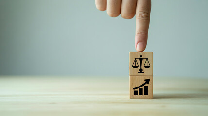 A minimalist business concept image featuring two wooden blocks with black icons on a light beige surface.