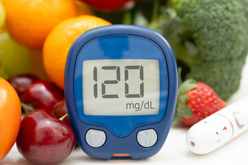 Glucose meter with vegetable and fruit for check sample blood sugar level to treatment diabetes.