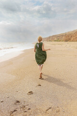 Woman standing on the seashore and enjoying freedom and nature