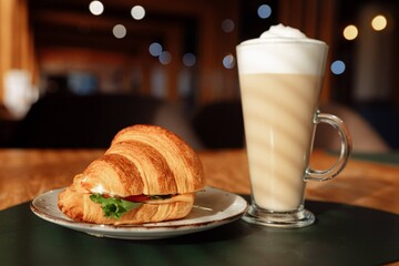A perfect breakfast pairing of croissant and latte in a warm caf ambiance