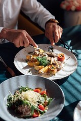A vibrant salad on an elegant plate showcases a sophisticated dining experience and culinary artistry