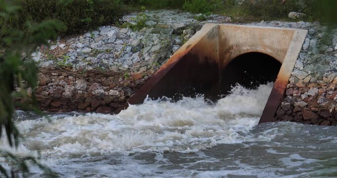 Overflow Tunnel: A concrete tunnel funnels a torrent of flowing water through a man-made structure, creating a dynamic scene of natural forces harnessed by human design. 
