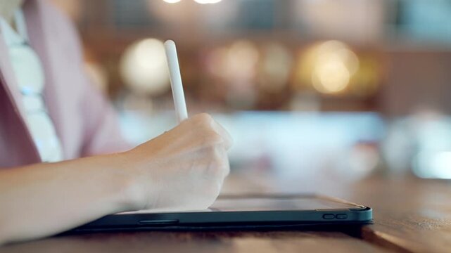 Close-up of UX UI designer hand using stylus pen on digital tablet, modern user interface design concept