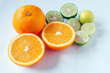 Citrus fruit of Halved orange fruit, slices lemon or lime fruit and bergamot fruit on white background,