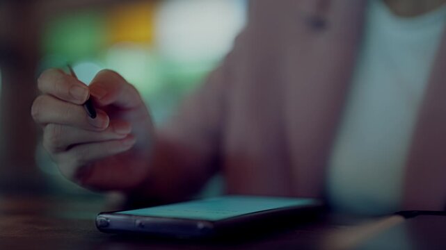 Businesswoman hands managing digital workflow with stylus pen, smartphone, and tablet