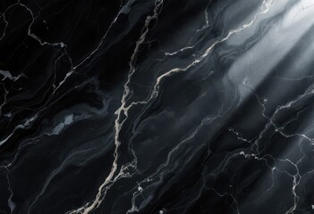 A dark, dramatic marble surface displays intricate veining and subtle light play.