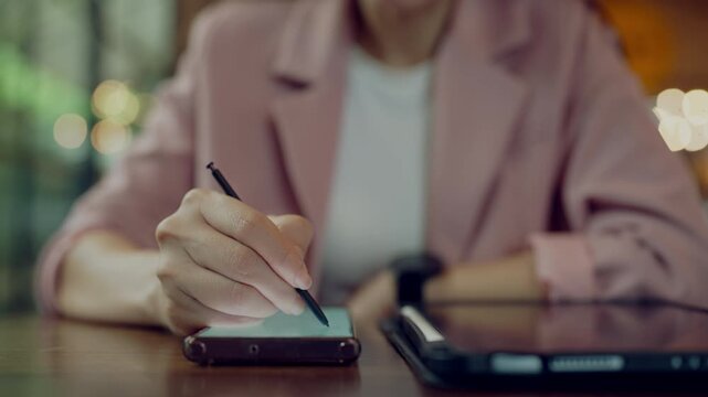 Tech-savvy woman using digital tablet, stylus and smartwatch for remote work, multitasking and digital efficiency