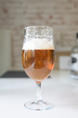Beer glass on home table vertical shot