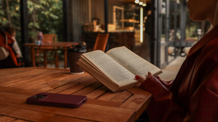 Woman reading a book at a cafe